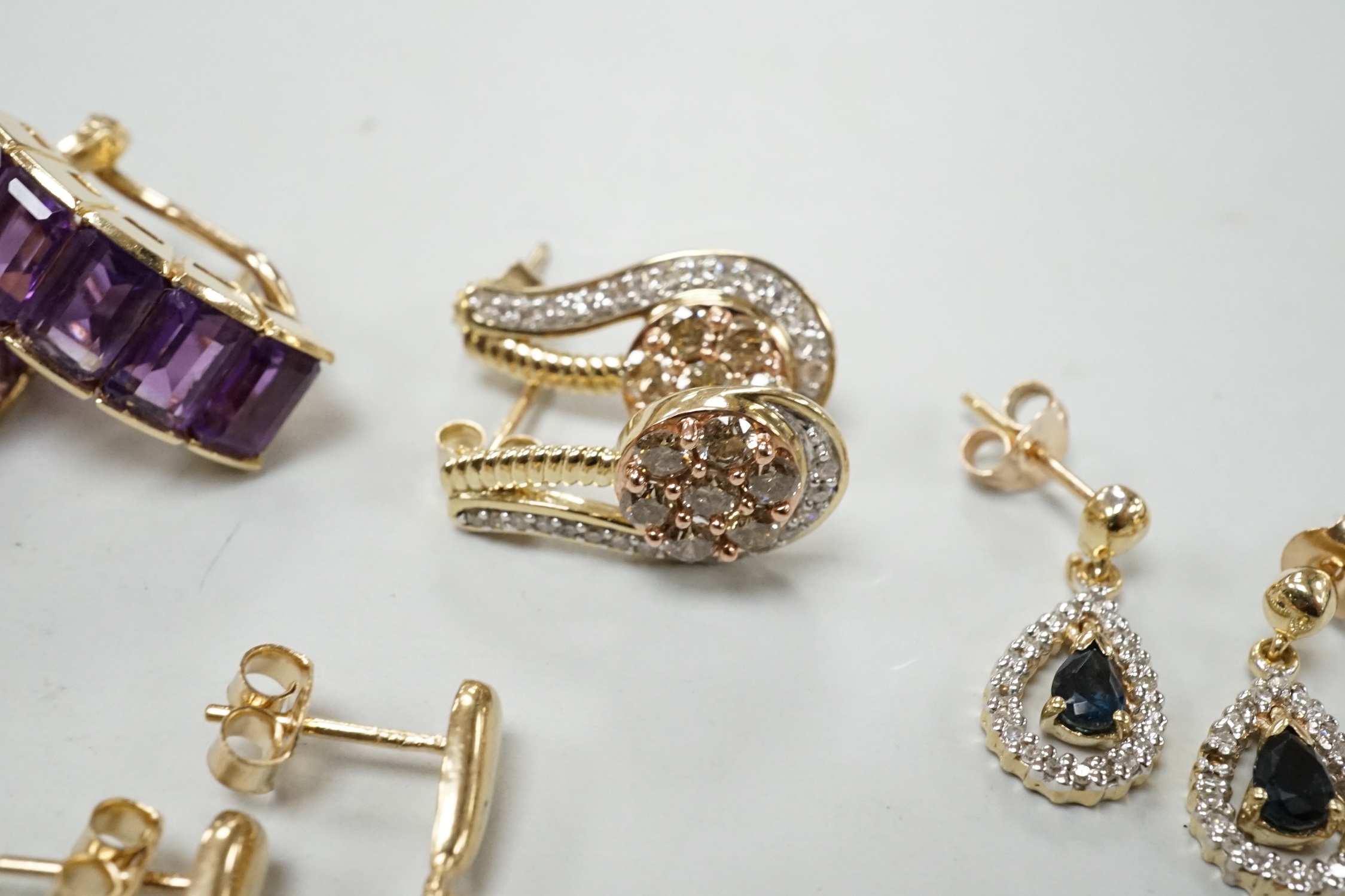 A modern pair of 585 yellow metal and five stone amethyst set demi lune earrings, 18mm, gross weight 6.2 grams, together with three modern pairs of 9ct and gem set earrings including two colour diamond cluster and one ot